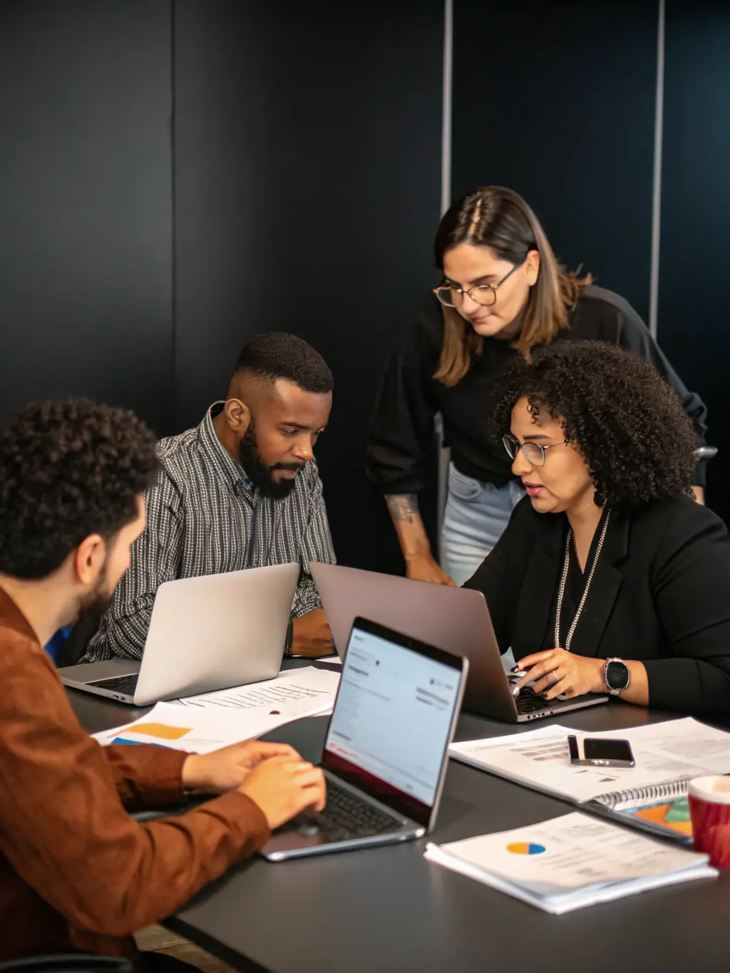 A diverse group of business professionals collaborating around a table, brainstorming innovative ideas and strategies for business growth.